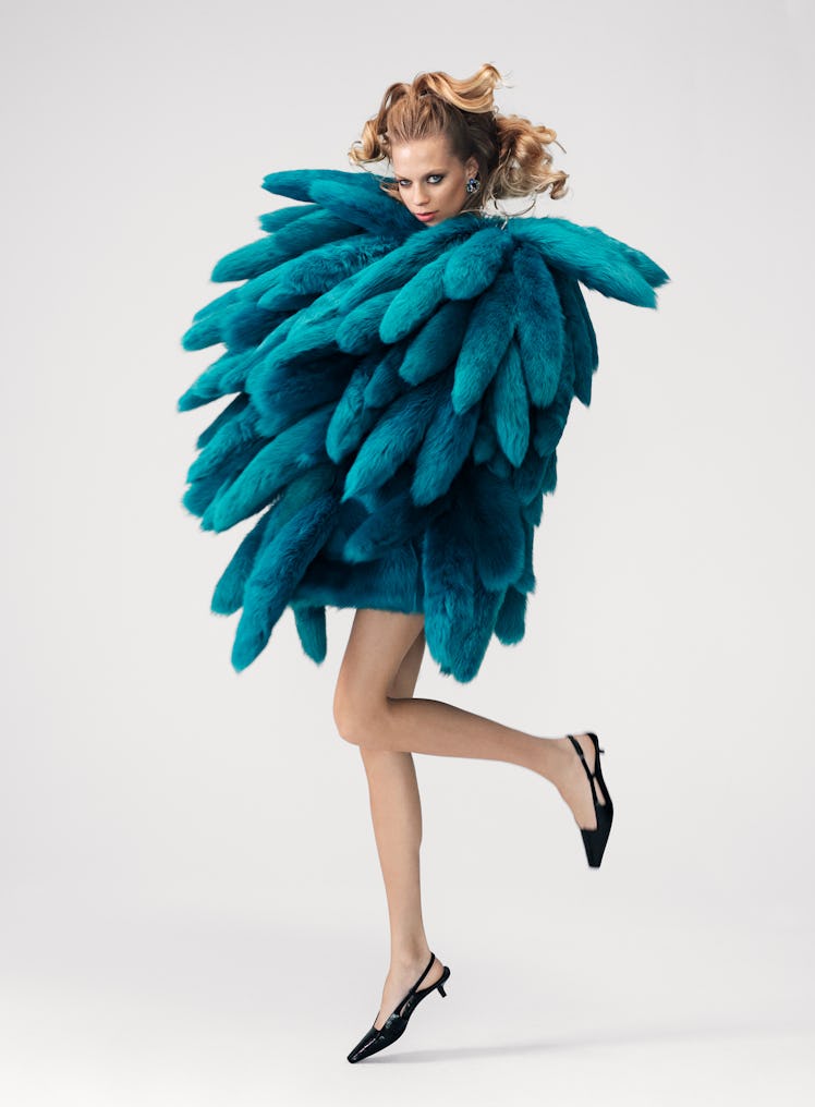 Lexi Boling wears a Bottega Veneta coat; Cartier earrings; Gucci shoes.