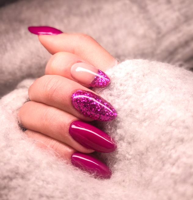 Manicure; deep magenta solid color and lighter shade sparkles on two nails