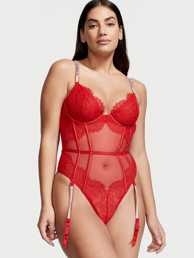 Woman modeling red one-piece lingerie