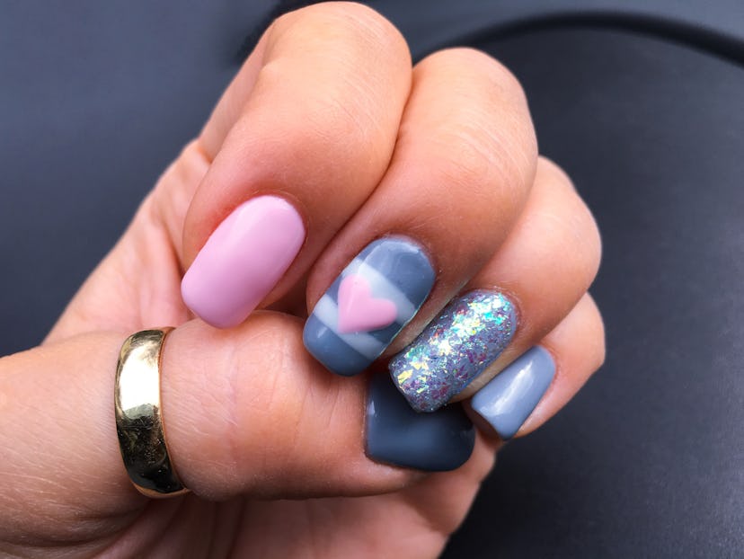 Manicure; nails in various designs in pinks and blues
