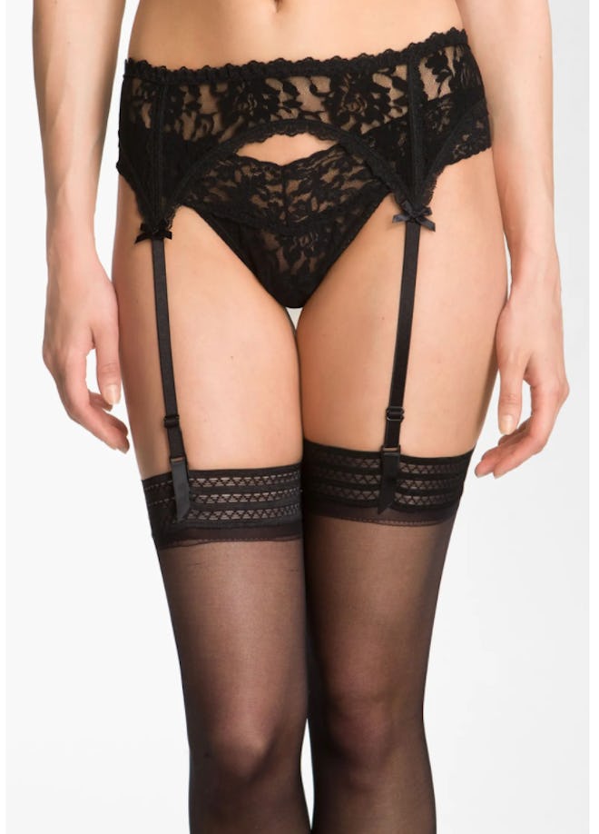 Bottom half of person modeling lingerie garter belt