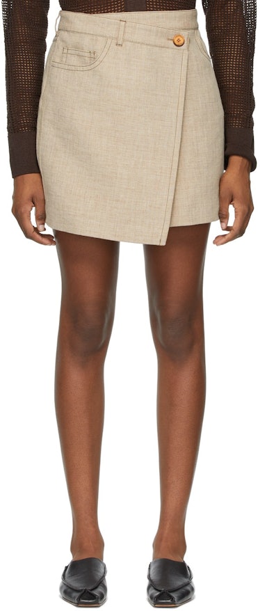 Acne Studios beige asymmetric miniskirt.