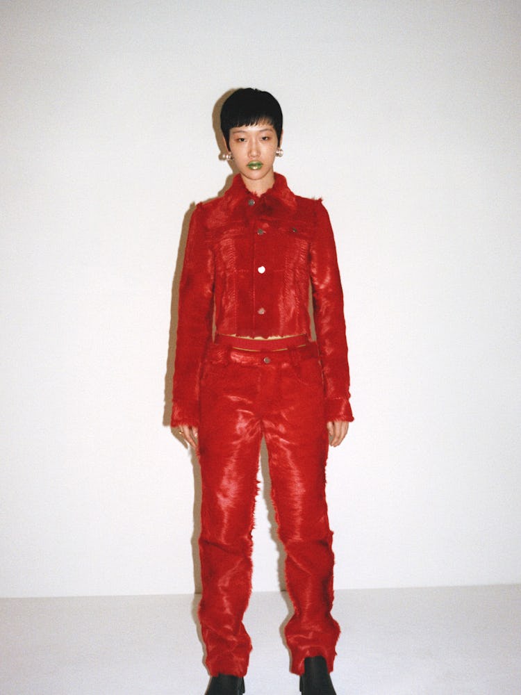 A model in a Bottega Veneta red jacket and pants set