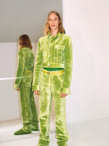 A model in a Bottega lime green set of matching pants and jacket 