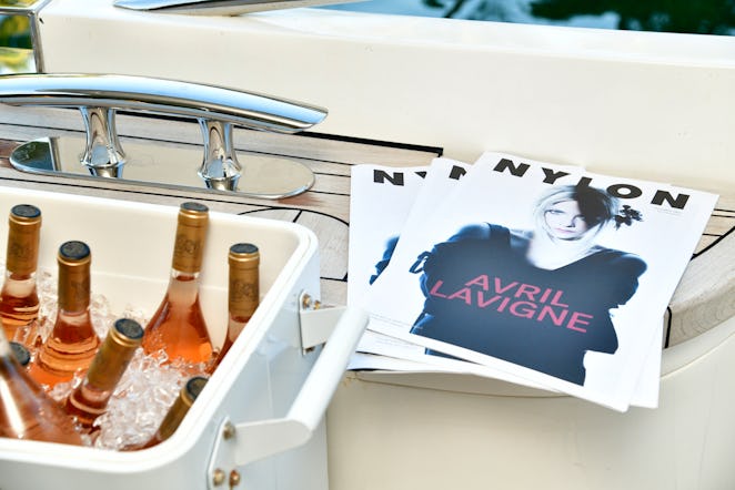 Bottles of alcohol and pictures of Avril Lavigne inside NYLON house at Art Basel Miami