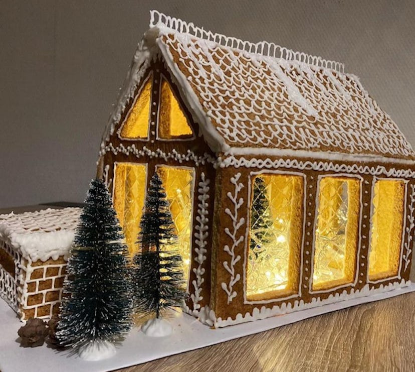 a gingerbread house with garage and glass windows