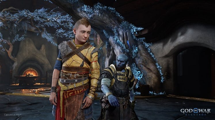 A slightly older Atreus alongside the blacksmith Brok, in a screenshot from God of War Ragnarok.