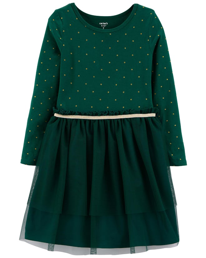Flat lay of green dress with gold dots