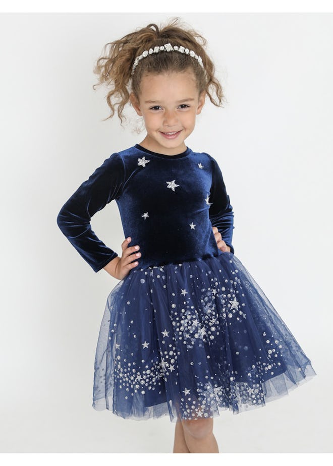 Little girl modeling long sleeve dress with sequins