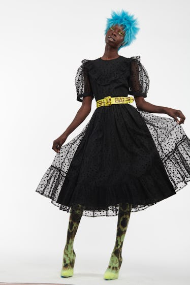 Batsheva black lacy dress and yellow caution tape belt