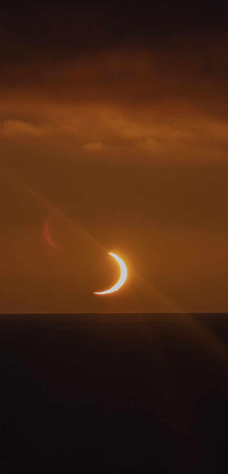 image of solar eclipse over antarctica