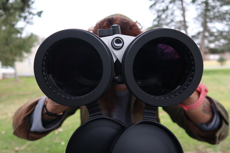 A closeup looking into the lenses of large binoculars