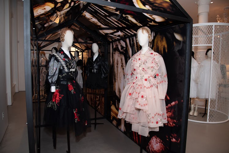 A stained glass installation with mannequins dressed in Simone Rocha designs