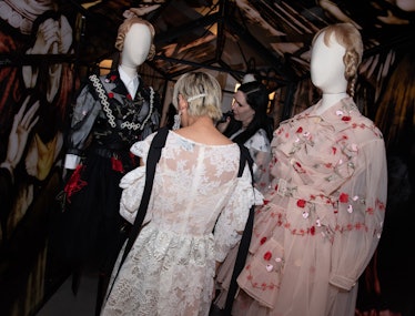 a woman looks at mannequins wearing simone rocha dresses