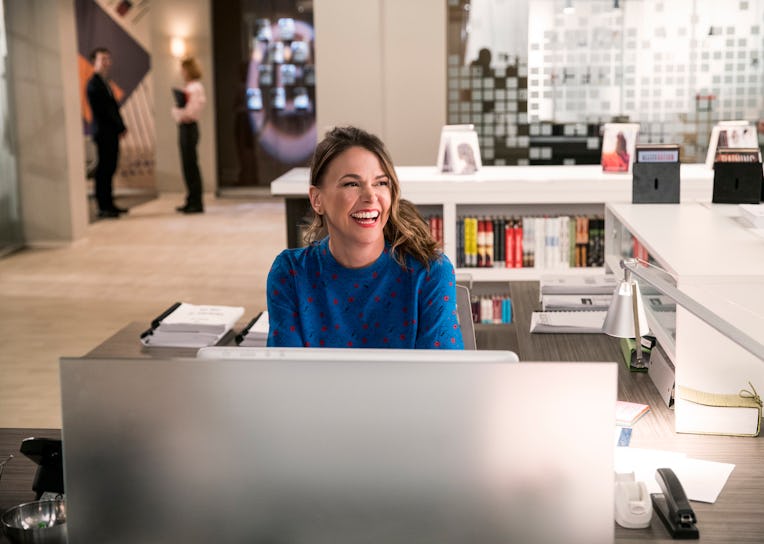 Liza Miller sitting at desk.