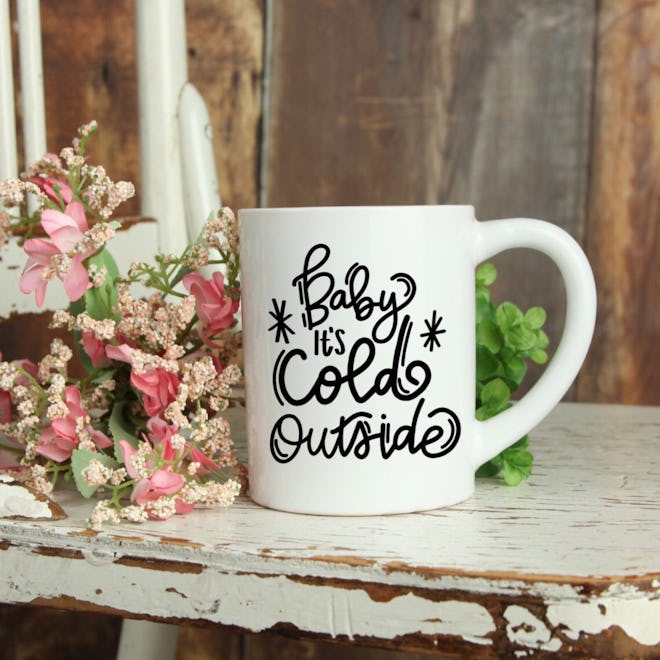 Coffee mug that says "baby it's cold outside"