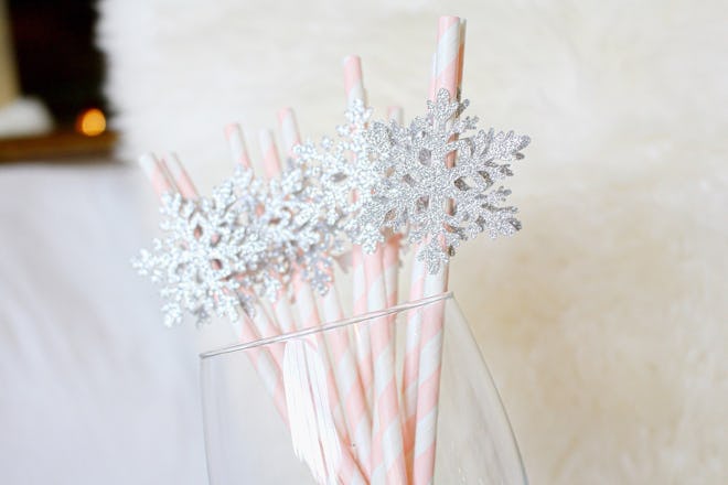 Glass jar full of paper straws with snowflakes