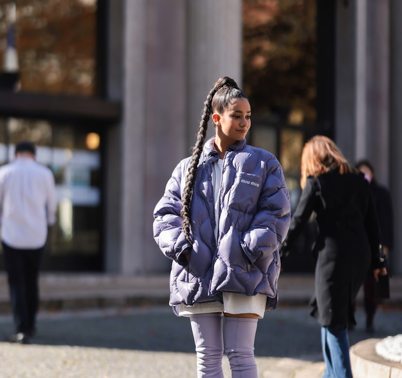Fashion Week guest wearing a purple jacket.