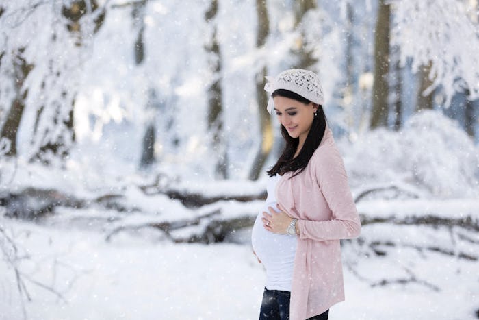 Pregnant woman outside in the snow