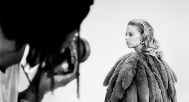 a model in a large furry coat being photographed