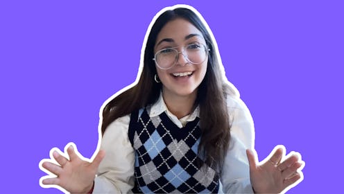 A woman in a black, grey, and blue sweater vest and a white shirt