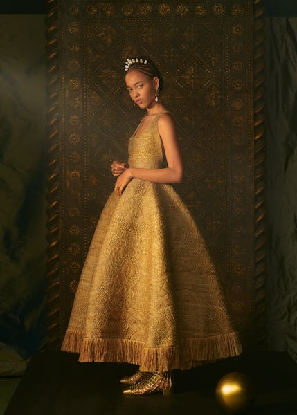 Model wears golden colored gown from Dior Haute Couture Spring/Summer 2021 collection.