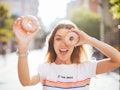 Woman holding two sprinkled donuts