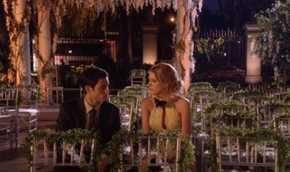 Dan and Serena sit in chairs from an outdoor wedding at night in 'Gossip Girl.'