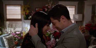 Cece and Schmidt embrace in 'New Girl' surrounded by flowers.
