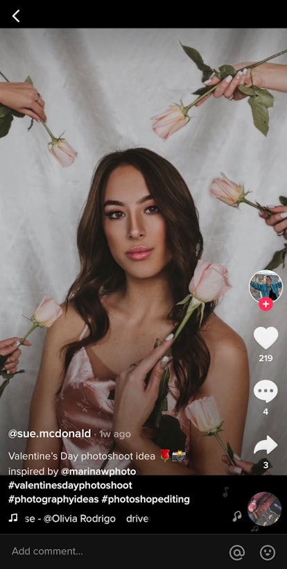 A TikTok user hands herself pink roses in a Valentine's Day picture idea for singles.