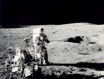 Apollo 14 astronaut Alan Shepard conducts a scientific experiment on the Moon