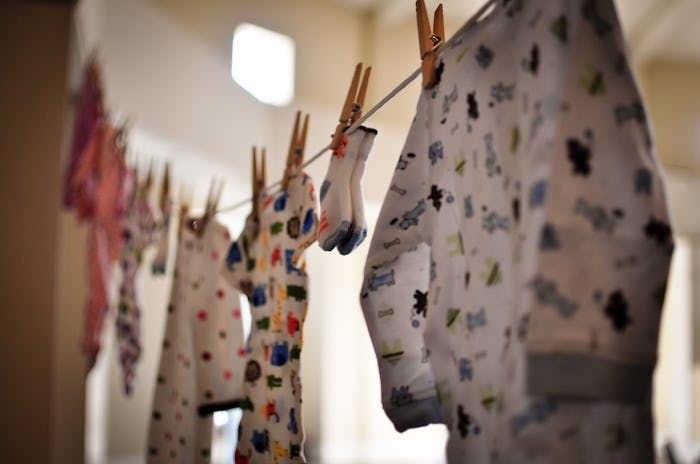 colorful baby onesies and socks hanging from a clotheslines