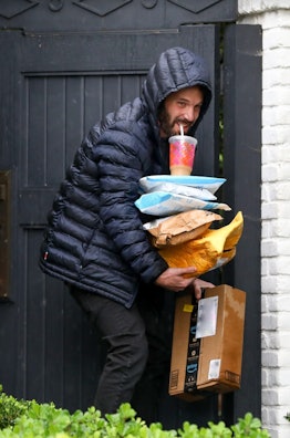 Ben Affleck carrying packages and Dunkin Donuts coffee