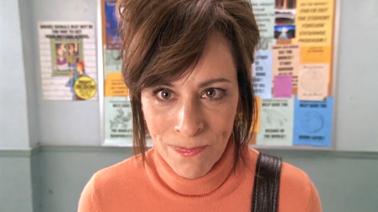 Lois from 'Malcolm in the middle' smiling in an orange turtleneck