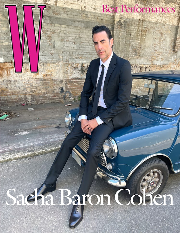 Baron Cohen wears a Prada suit, shirt, and tie; Falke socks; Manolo Blahnik shoes; his own ring.