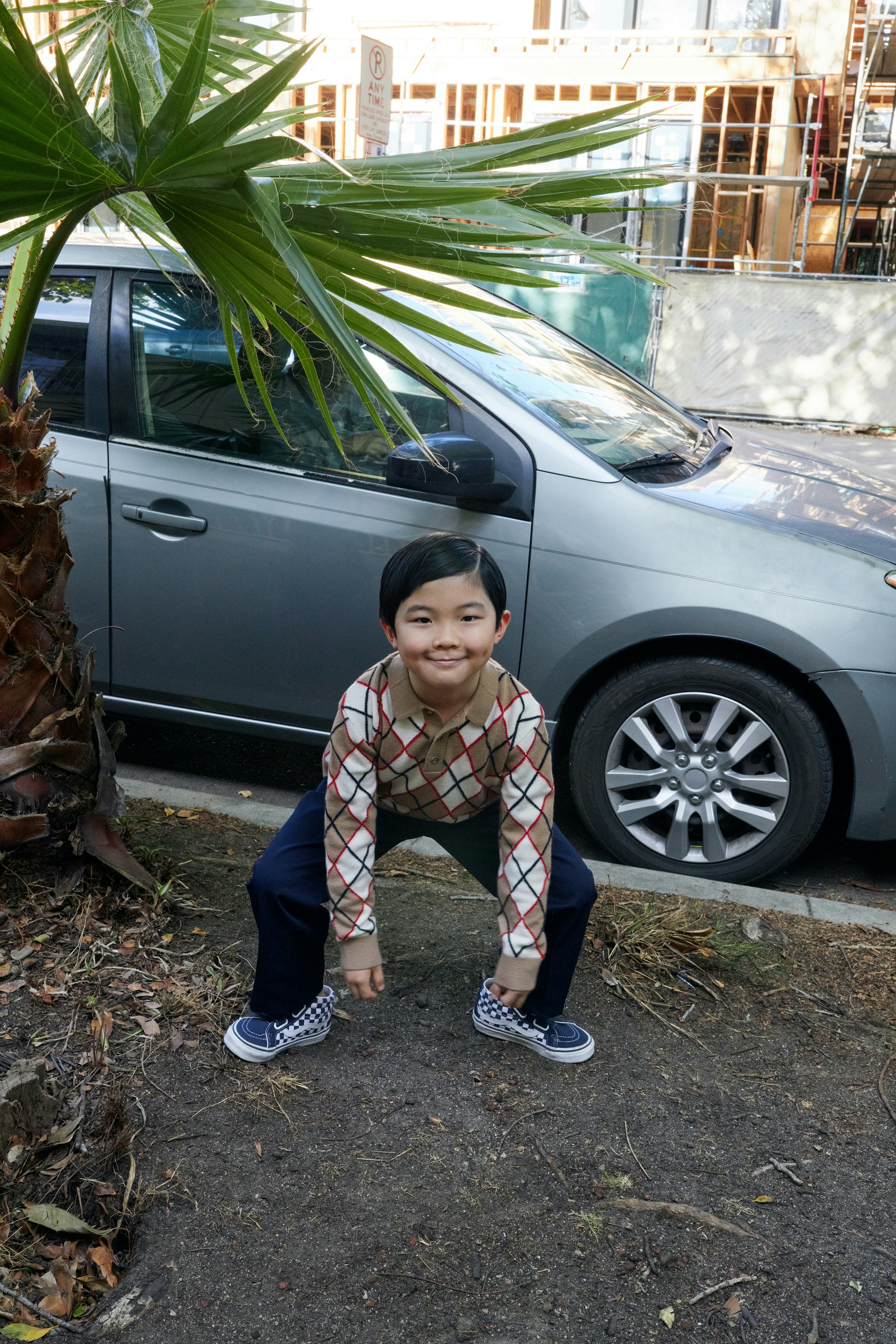 Alan Kim wears a Burberry sweater; Gucci pants; Vans sneakers.