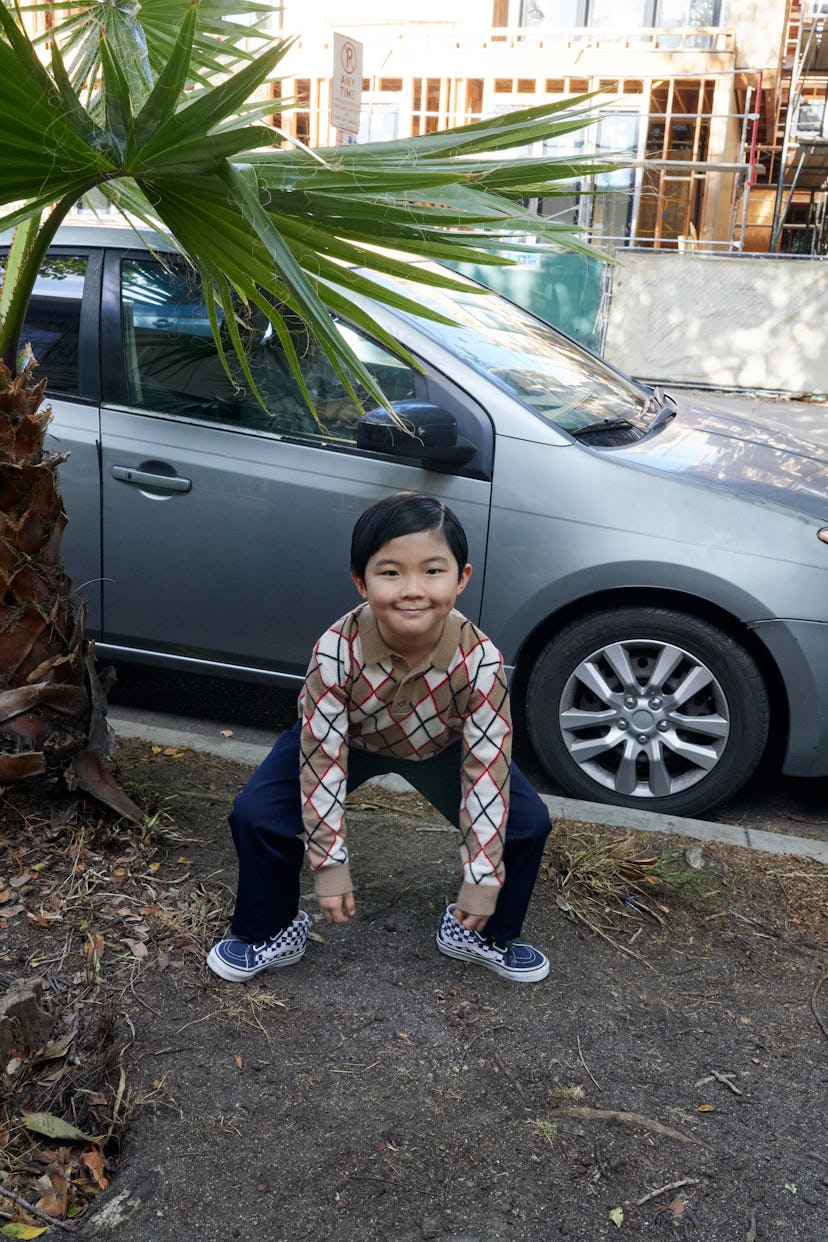 Alan Kim wears a Burberry sweater; Gucci pants; Vans sneakers.