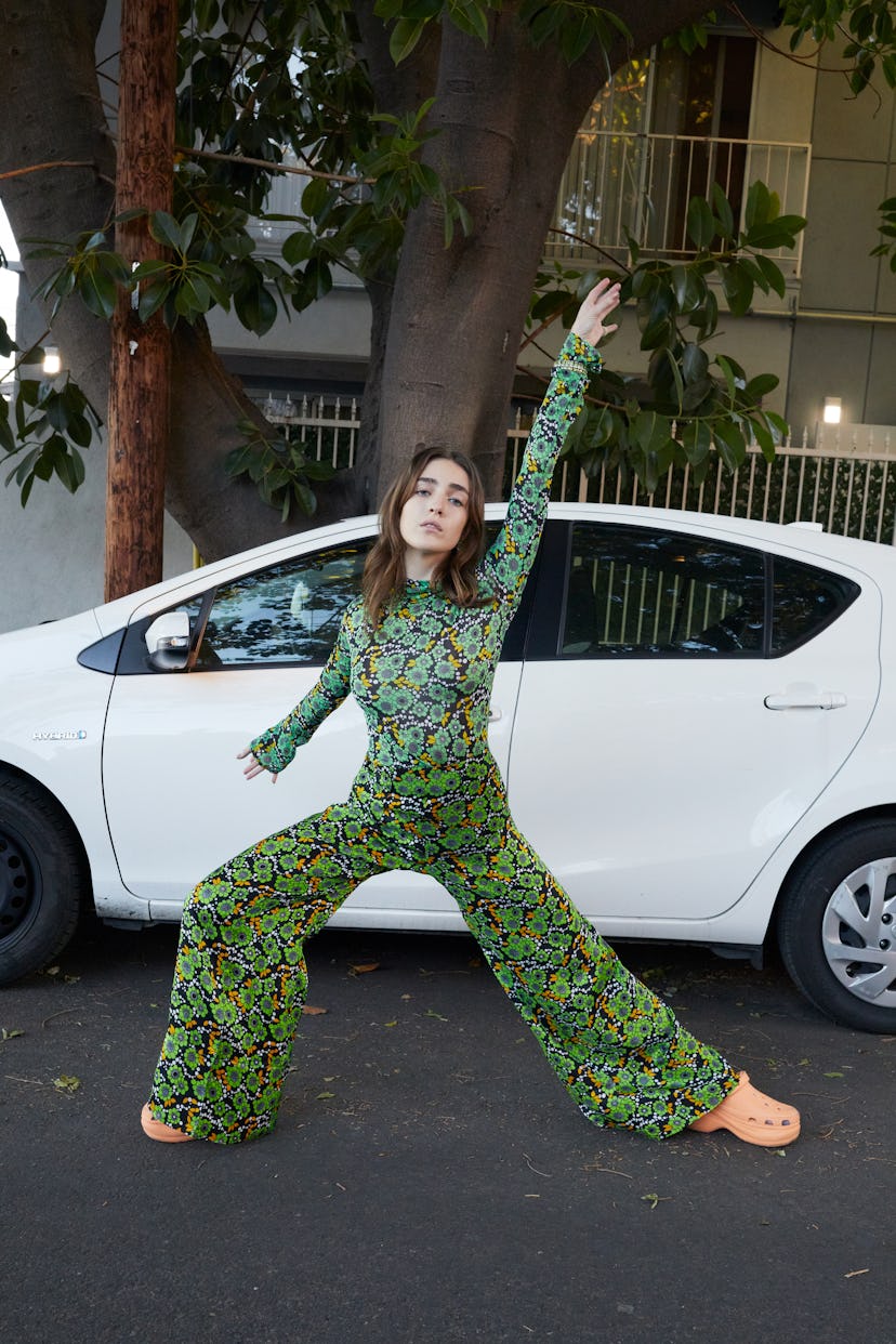 Talia Ryder wears a Kwaidan Editions top and pants; Cartier earrings, bracelet, and ring; Crocs shoe...