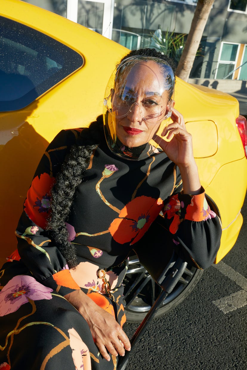 Tracee Ellis Ross wearing a Gucci dress and belt next to a yellow card
