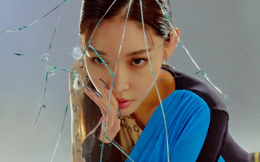 A portrait of Chung Ha. It shows the 25-year-old South Korean pop star in a blue and black shirt, wi...