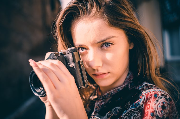 Young woman holding camera