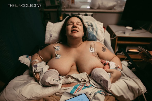 A woman breastfeeds newborn twins while lying in a hospital bed with her eyes closed. 