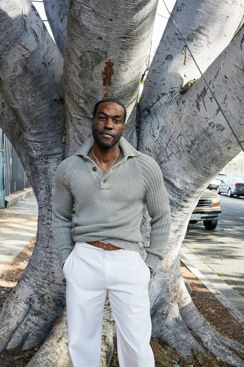 Yahya Abdul-Mateen II wears an Hermès sweater, pants, and belt; Cartier watch; his own necklace.