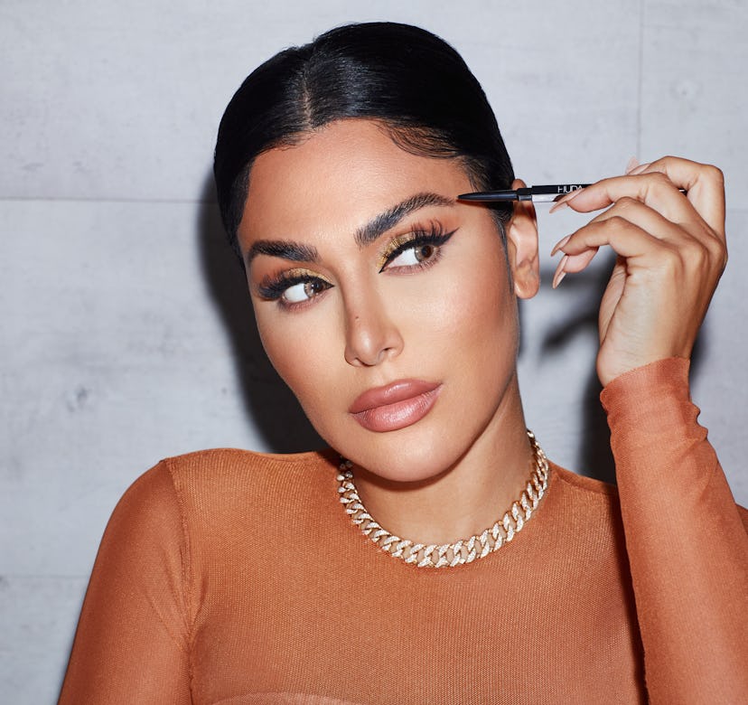 Huda Kattan using Huda Beauty's new #BOMBBROWS Brow Pencil.