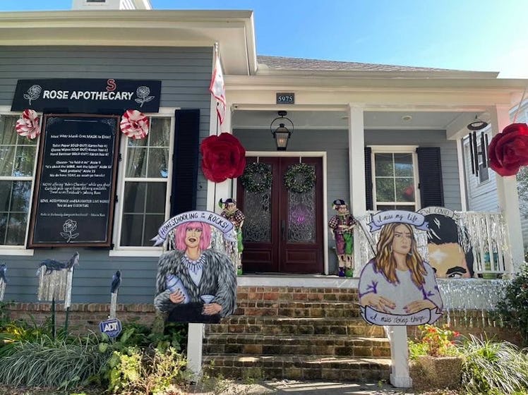 A house decorated like 'Schitt's Creek' for Mardi Gras has a Moira Rose and Alexis Rose cutout in th...