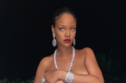 Rihanna posing for a photo wearing a necklace with the likeness of Ganesha, which sparked controvers...