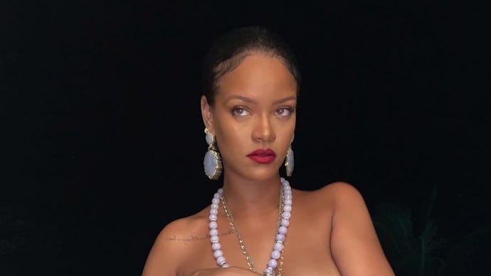 Rihanna posing for a photo wearing a necklace with the likeness of Ganesha, which sparked controvers...
