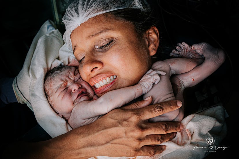 A woman cradles a newborn baby to her cheek in one of 26 award-winning birth photographs.