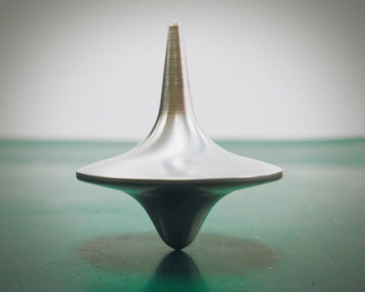 Close-Up Of Spinning Top On Table
