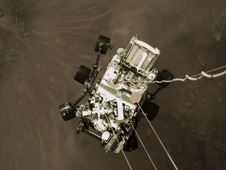 An image of the Perseverance rover as it descends to the surface of Mars. 